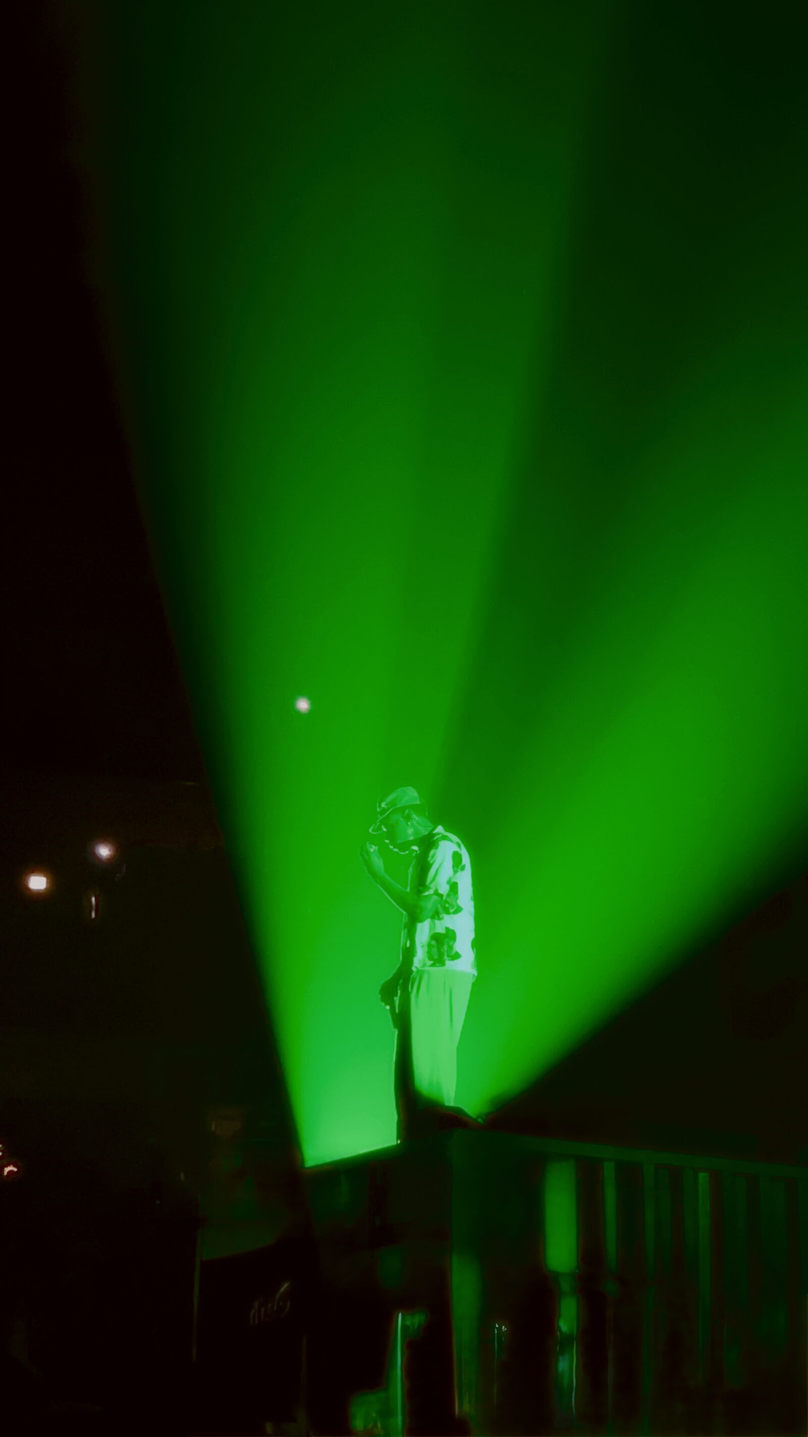 Wide concert stage viewed through a textured curtain of light