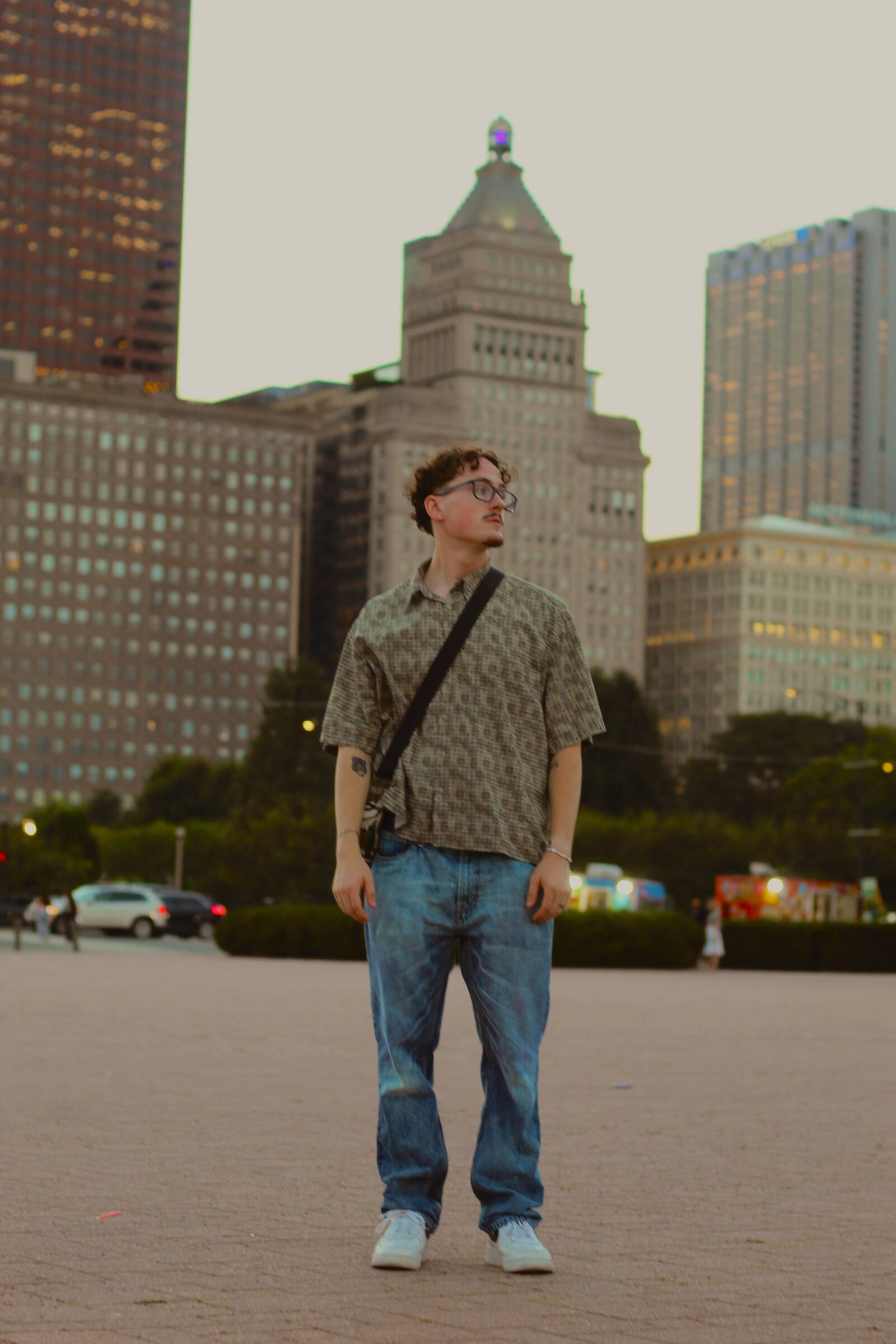 Portrait subject seated in a bright city park