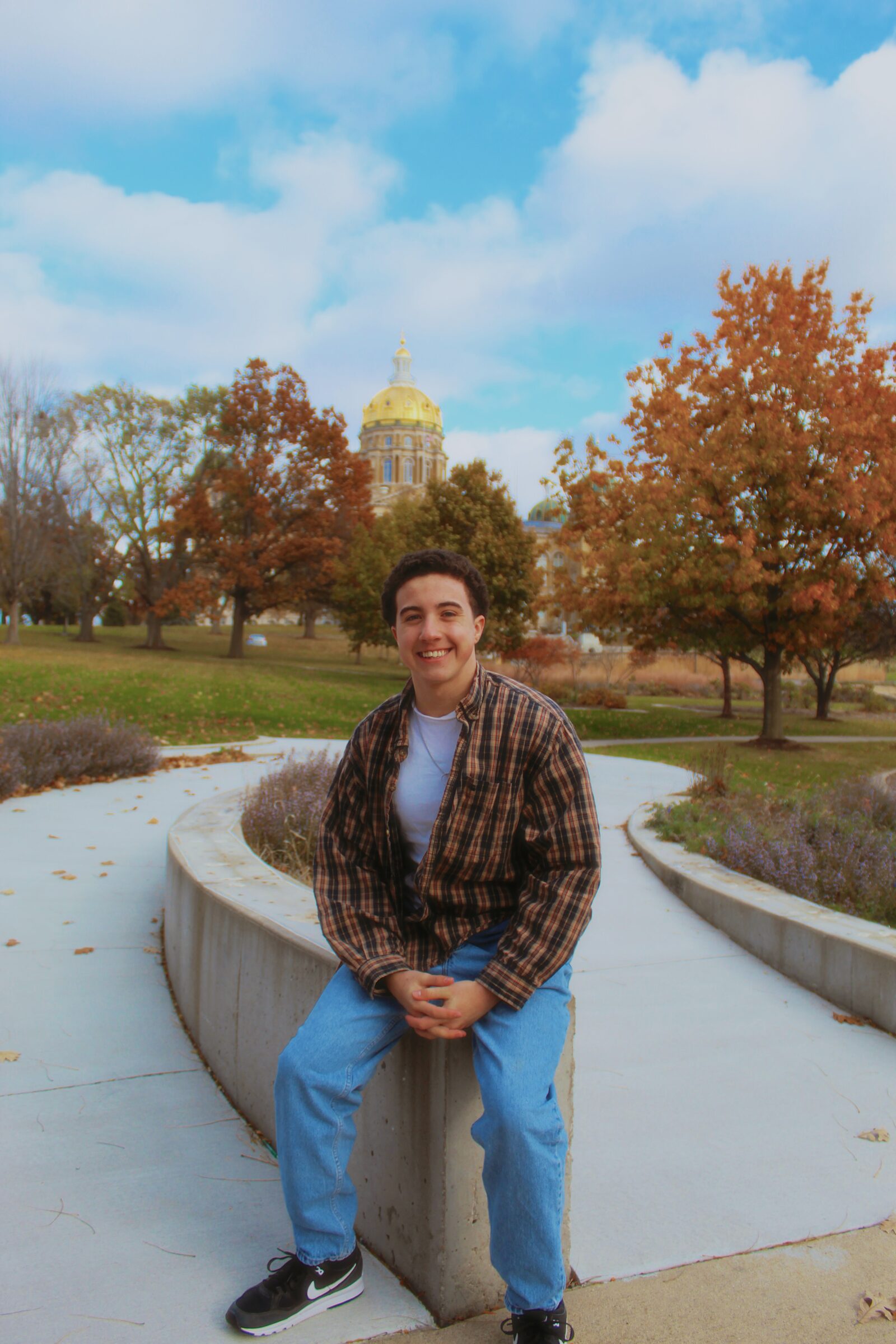 Distant portrait subject seated in an expansive city park